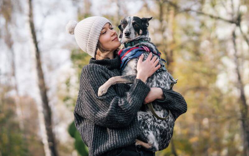 Woman camping holding dog